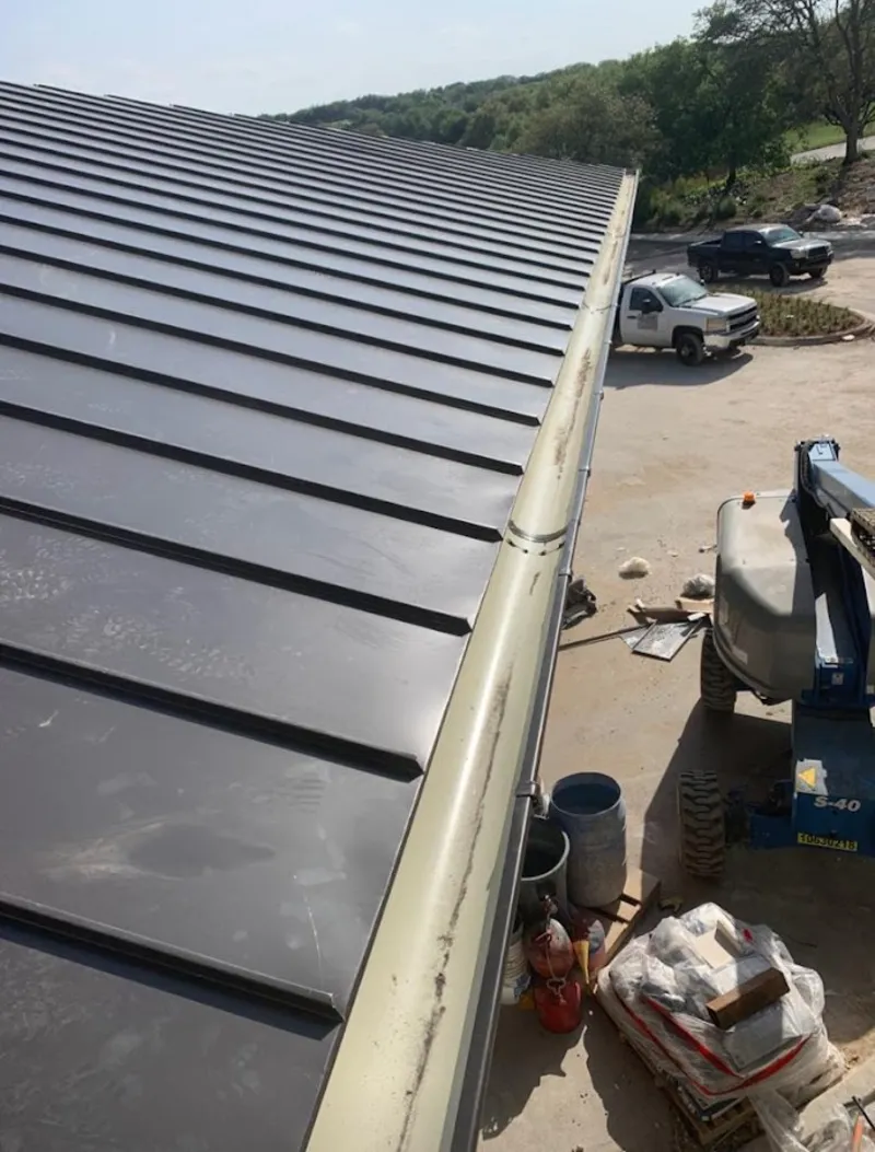 Standing seam panel and gutter detail on a metal roofing jobsite in Fortuna Foothills